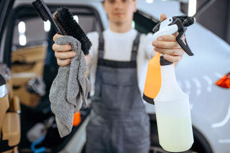 Worker shows tools for dry cleaning and detailingの写真素材