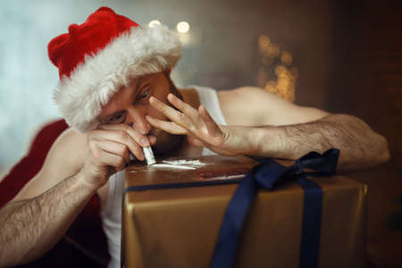 Bad Santa claus takes drugs, cocaine party, humorの写真素材