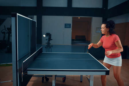 Woman hits the ball at the wall, table tennisの写真素材