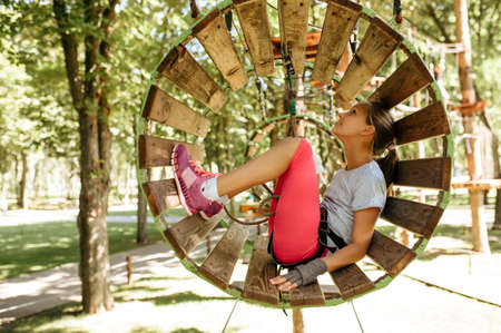 Teens in equipment climbs in rope park, playgroundの写真素材