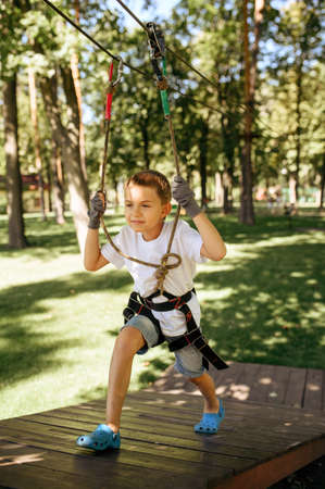 Little boy climbs in rope park, top viewの写真素材