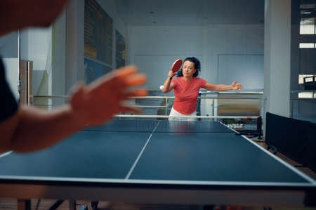 Sportive man and woman, table tennis trainingの写真素材