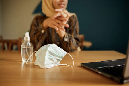 Mask and antiseptic, arab girl on backgroundの写真素材