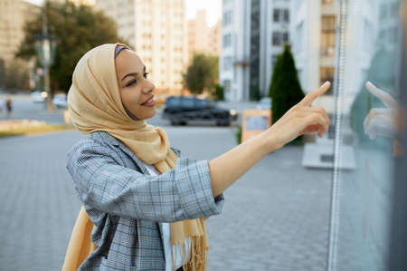 Arab female student looking on map in downtownの写真素材
