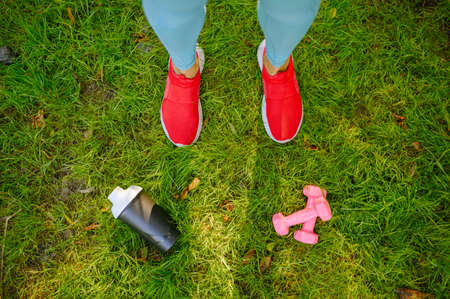 Woman on fit training in park, top view on feetsの写真素材