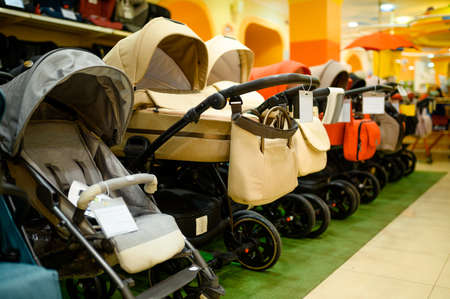 Row of baby strollers in childrens store, nobody