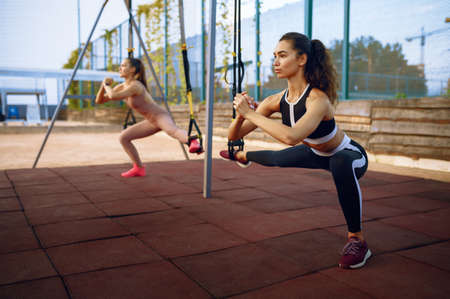 Slim women doing balance exercise, group trainingの写真素材