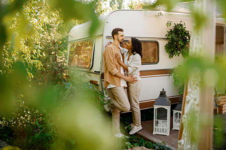 Love couple embraces in rv, camping in a trailerの写真素材