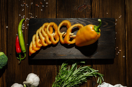 Fresh cutted pepper on board, top view