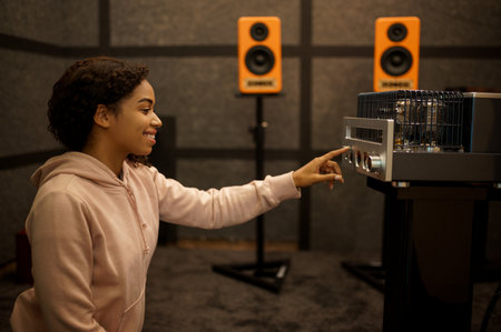 Woman using amplifier in speaker system store