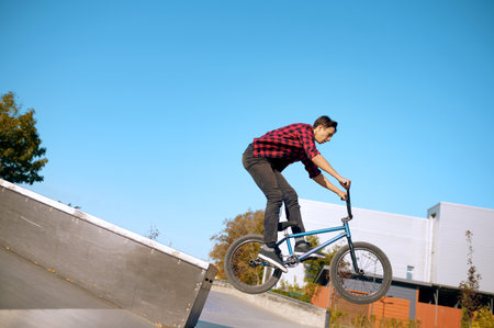 Bmx biker doing trick on stairs in skateparkの写真素材