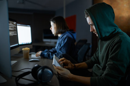 Male and female hackers works in darknet