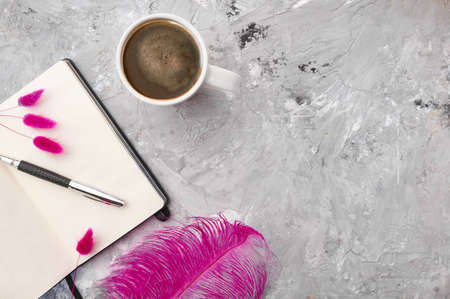 Cup of coffee, opened notepad and pen, stationeryの写真素材