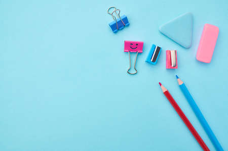 Pencils, clips and rubber on blue backgroundの写真素材
