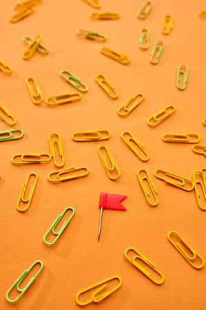 Paper clips closeup, orange background, stationeryの写真素材