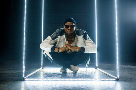 Stylish rapper in gold jewelry and sunglassesの写真素材