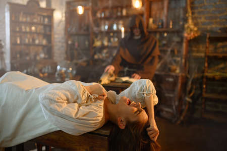 Exorcist casting out demons from crazy womanの写真素材