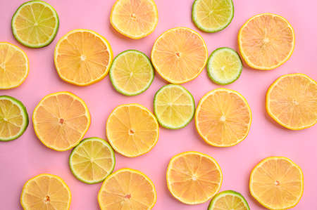 Fresh kiwi and lemon slices on yellow backgroundの写真素材