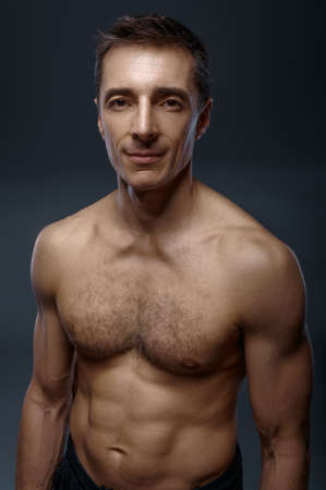 Male yoga with muscular body on grey backgroundの写真素材