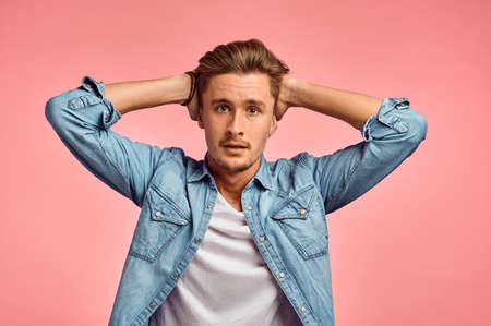 Stressed man portrait, pink background, emotion