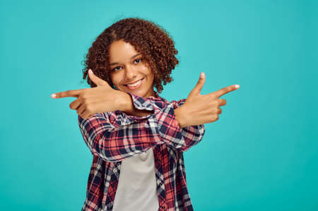 Young woman with crossed hands, blue background