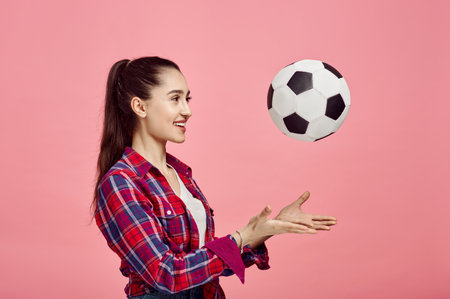 Portrait of young woman with football ballの写真素材