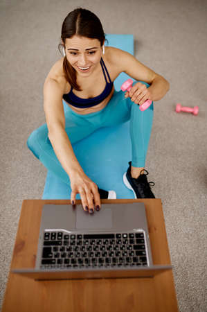 Girl sitting at the laptop, online fit training