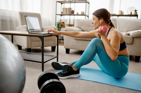 Girl sitting at the laptop, online fit trainingの写真素材
