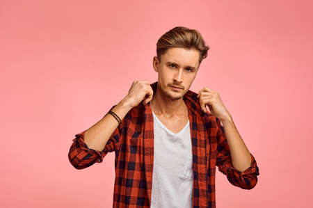 Serious man portrait, pink background, emotionの写真素材