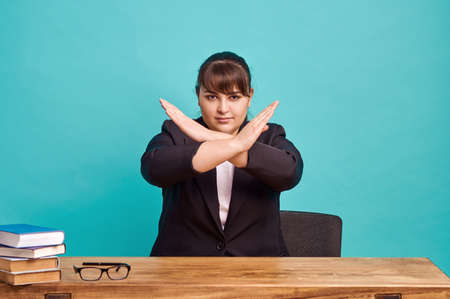 Strict overweight teacher shows stop gestureの写真素材