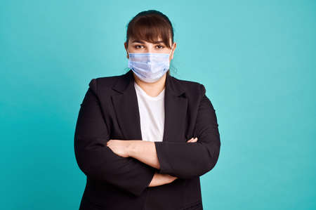 Overweight woman in suit and medical maskの写真素材