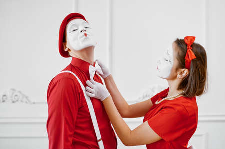 Mime artists in red costumes look at each otherの写真素材