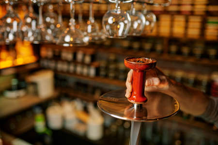 Hookah maker, smoking preparation in barの写真素材