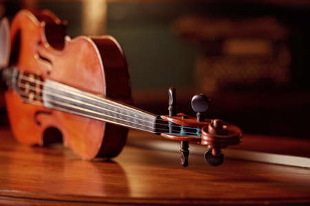 Violin in retro style on wooden table, closeupの写真素材