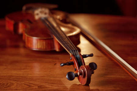 Violin in retro style on wooden table, closeup