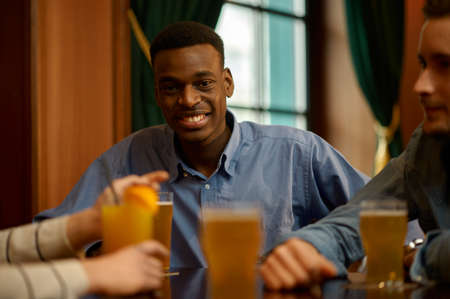 Cheerful friends having fun at the table in barの写真素材