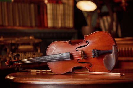 Violin in retro style on wooden table, closeupの写真素材