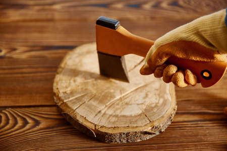 Male hand in glove holds an axe, woodworkerの写真素材
