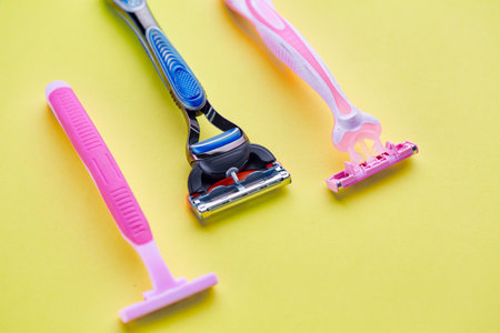 Skin care products, razors on yellow backgroundの写真素材