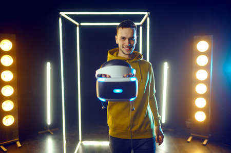 Young gamer poses with virtual reality headset