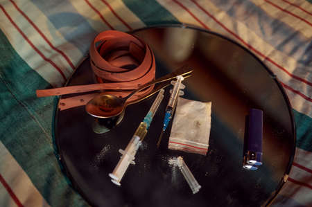 Drug addicts tools, syringe, spoon and tourniquetの写真素材