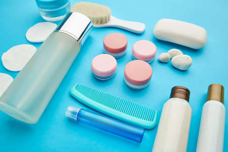 Face care products on blue background, nobody