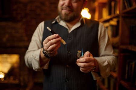 Smiling man smokes cigarette with mouthpiece