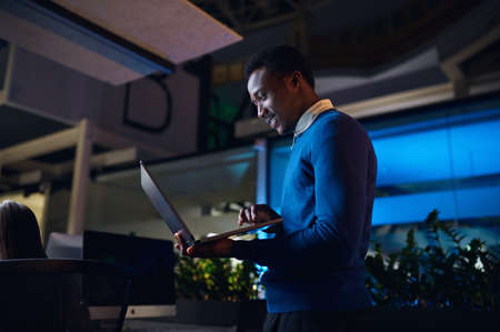 One manager works on laptop in night office