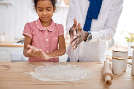 Father and daughter cooking cakes on breakfastの写真素材