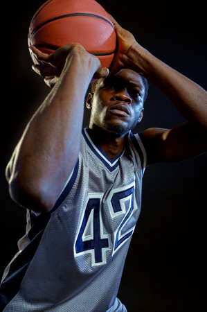Basketball player throws a ball in studio
