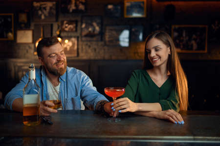 Couple with alcohol gets acquainted in barの写真素材