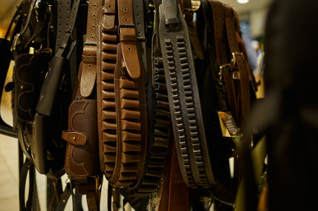 Different leather bandoliers in gun store, nobodyの写真素材
