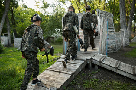 Paintball team shoots with guns, military game