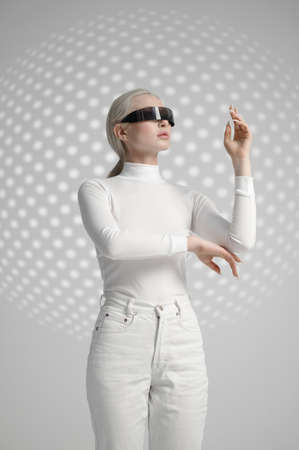 Woman in white clothes and futuristic glassesの写真素材